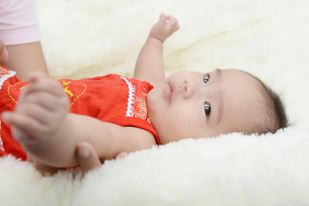 Baby wearing a red dress will celebrate the Chinese New Year.の写真素材