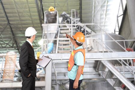 Engineer and supervisors are checking manufacturing.の写真素材