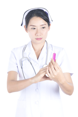 Beautiful nurse with a syringe on white background.の写真素材