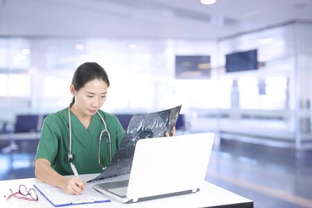 Doctor examine patient data in the office.の写真素材