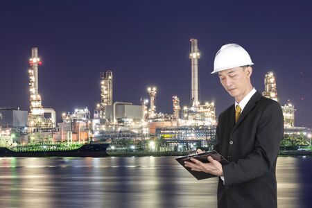 Supervisor are checking oil production schedule.の写真素材