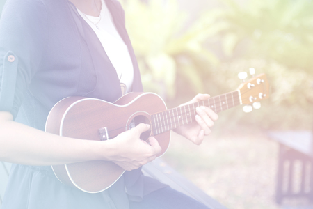 Beautiful woman are studying to play ukulele.の写真素材