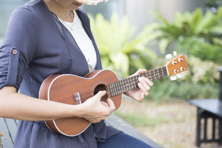Beautiful woman are studying to play ukulele.の写真素材