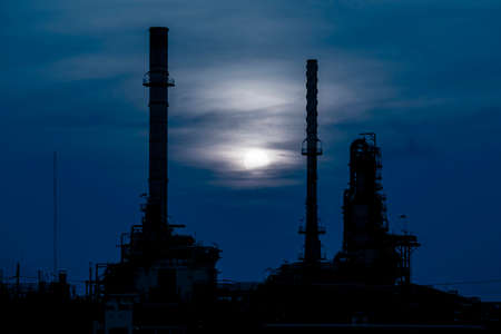 Silhouette of oil refinery factory in nightの写真素材
