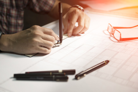 Architects will design the construction plans seriously. Hard work should care about the health of the eyes.の写真素材