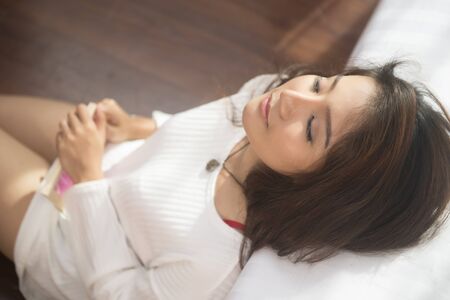 Beautiful women relaxing in the bedroomの写真素材