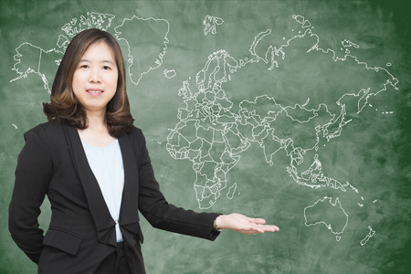 "Back to school" concept : Beautiful young teacher with a blackboard.の写真素材