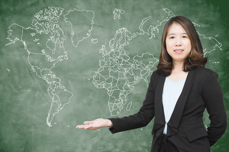 "Back to school" concept : Beautiful young teacher with a blackboard.の写真素材