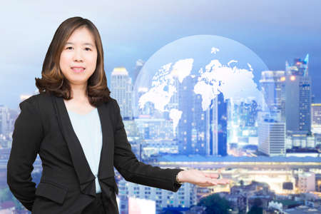 Businesswoman with maps and globes.の写真素材