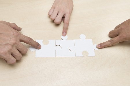 Pictures of guests per puzzles on wood table.の写真素材