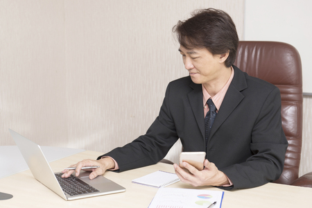 Young asian businessman working in an office.の写真素材