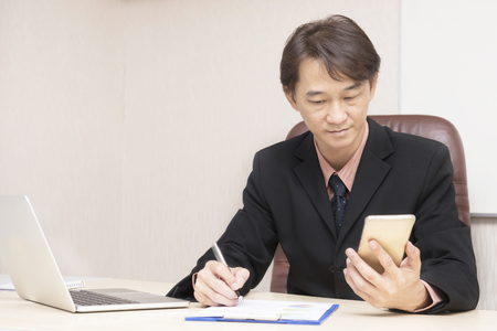 Young asian businessman working in an office.の写真素材