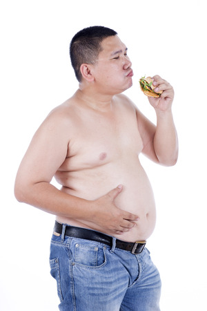 Belly fat people at large from eating behaviors. Junk food. Enjoy eatingの写真素材