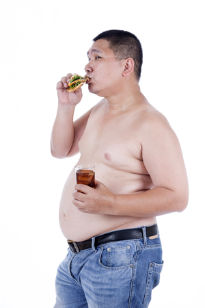 Belly fat people at large from eating behaviors. Junk food. Enjoy eatingの写真素材