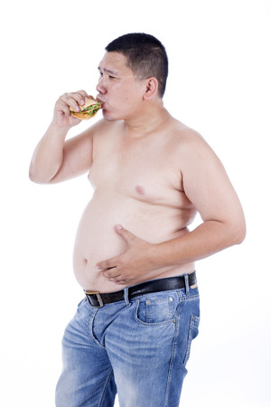 Belly fat people at large from eating behaviors. Junk food. Enjoy eatingの写真素材