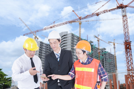 Engineer, supervisor and staff are checking the building construction.