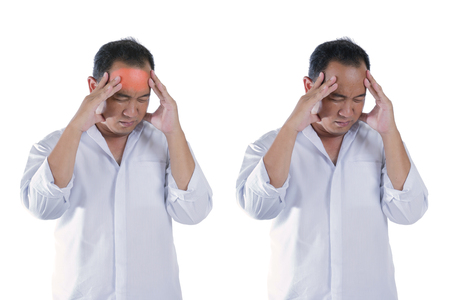 Men's stress headache from working on a white background.の写真素材