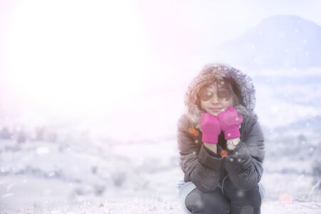 Beautiful women are enjoying a winter snow.の写真素材