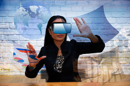 Businesswoman wearing a three-dimensional glasses working technology of the future.の写真素材