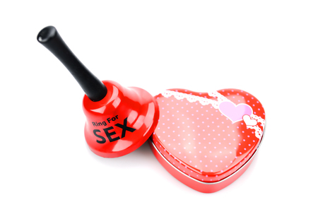 Heart shaped box and bell on a white background.の写真素材