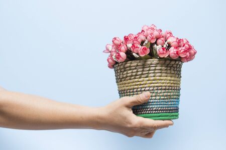 Hand held giving flowers for Valentine's Day.の写真素材
