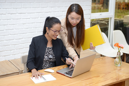 Businesswoman working with documents and laptopの写真素材