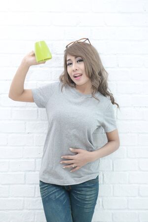 Beautiful women satisfied and happy after drinking milk.の写真素材
