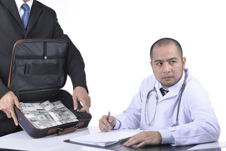 The doctor signed agreed reluctantly to a business agreement.の写真素材