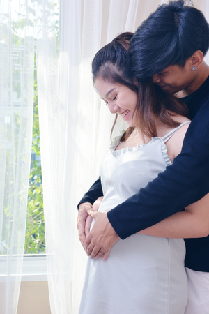 Pregnant women and husbands is happy, when I think of the baby to be born.の写真素材