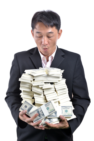 A lot of money in the hands of a young businessman.の写真素材