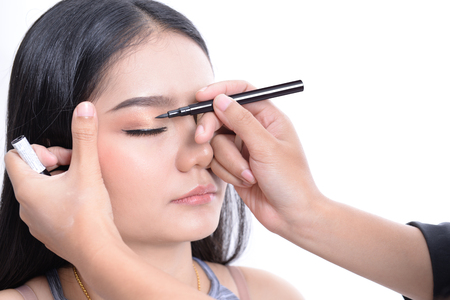 Make-up artist is working with beautiful modelの写真素材