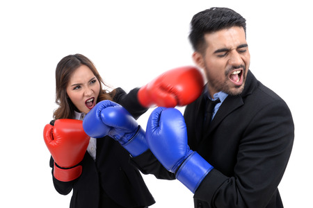 Business competition concept: Young businesswoman fighting not afraid of the businessmenの写真素材