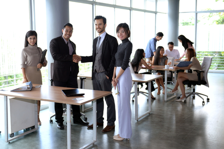 Handshake : The image of a businessman is holding hands. Business partnerships will lead to success.の写真素材