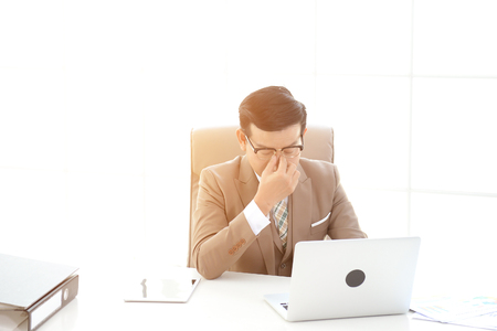 Businessman are working a rush working in office. Hard work can affect health.の写真素材