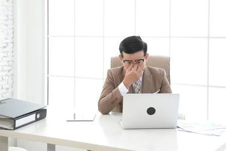 Businessman are working a rush working in office. Hard work can affect health.の写真素材