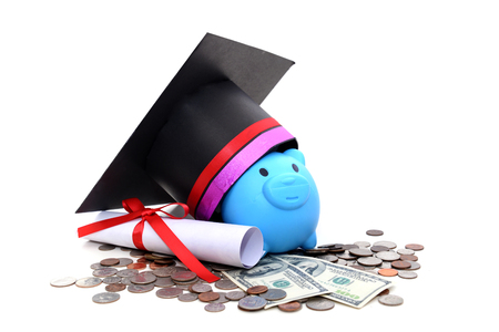 Congratulation concept: Piggy bank with a graduation hat With the concept of scholarship fundingの写真素材