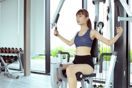 Exercise in the gym, women want to have a beautiful body with fitness.