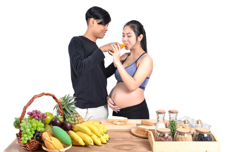 Pregnant women drink orange for baby health.の写真素材