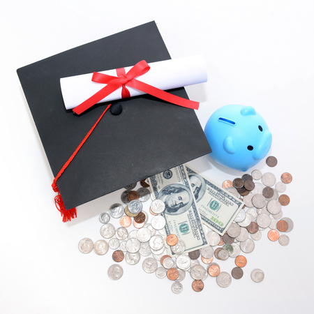Congratulation concept: Piggy bank with a graduation hat With the concept of scholarship fundingの写真素材