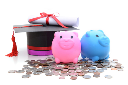 Congratulation concept: Piggy bank with a graduation hat With the concept of scholarship fundingの写真素材