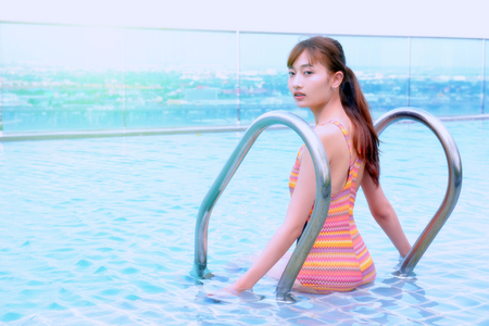 The girl is enjoying swimming. In the pool area of ââthe condo Condominium.の写真素材