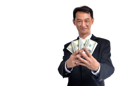 A lot of money in the hands of a young businessman.の写真素材