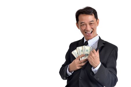 A lot of money in the hands of a young businessman.の写真素材