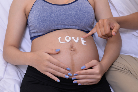 Expression of love The warmth of the couple and their children were born.の写真素材