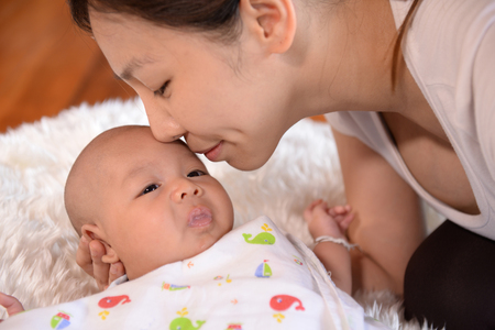 Expression of love warmth Mother and babyの写真素材