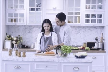Husband and wife show love to each other. The wife is pregnant.の写真素材