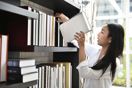 Young student are searching for information from books in the library.の写真素材
