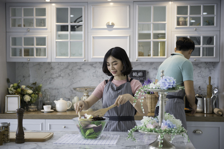 Couples with family activities, young men and women are cooking in the kitchen.の写真素材
