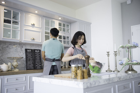 Couples with family activities, young men and women are cooking in the kitchen.の写真素材