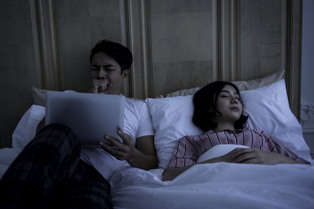 Couples with family activities, sleep is the best way to sleep at least eight hours a day.の写真素材